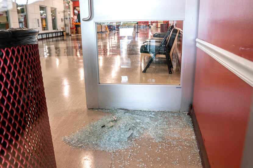 A pile of broken glass from a door sat just inside the west entrance to the Duncanville...