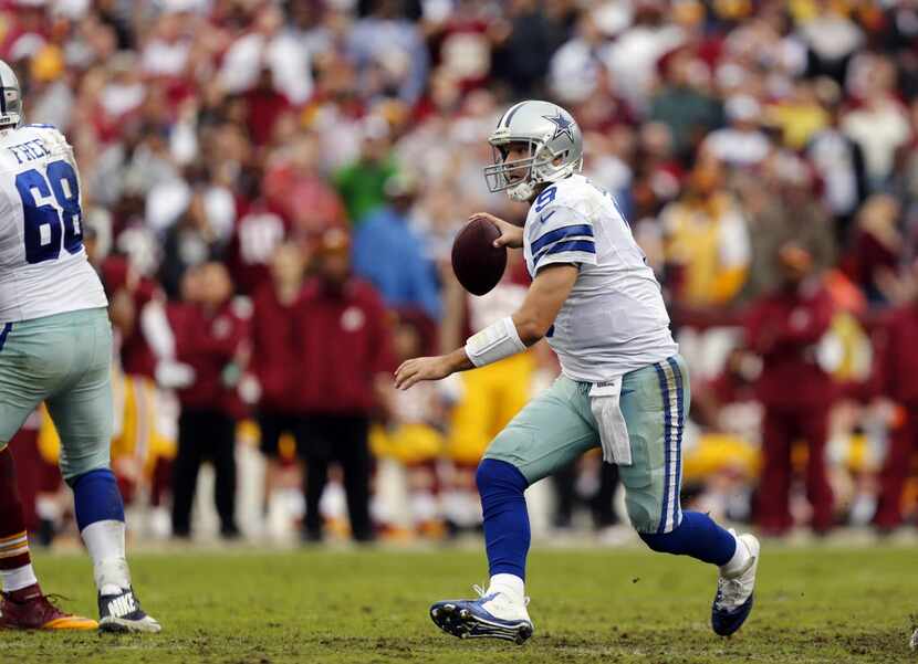 Dallas Cowboys quarterback Tony Romo (9) scrambles as he looks for a reciever during the...