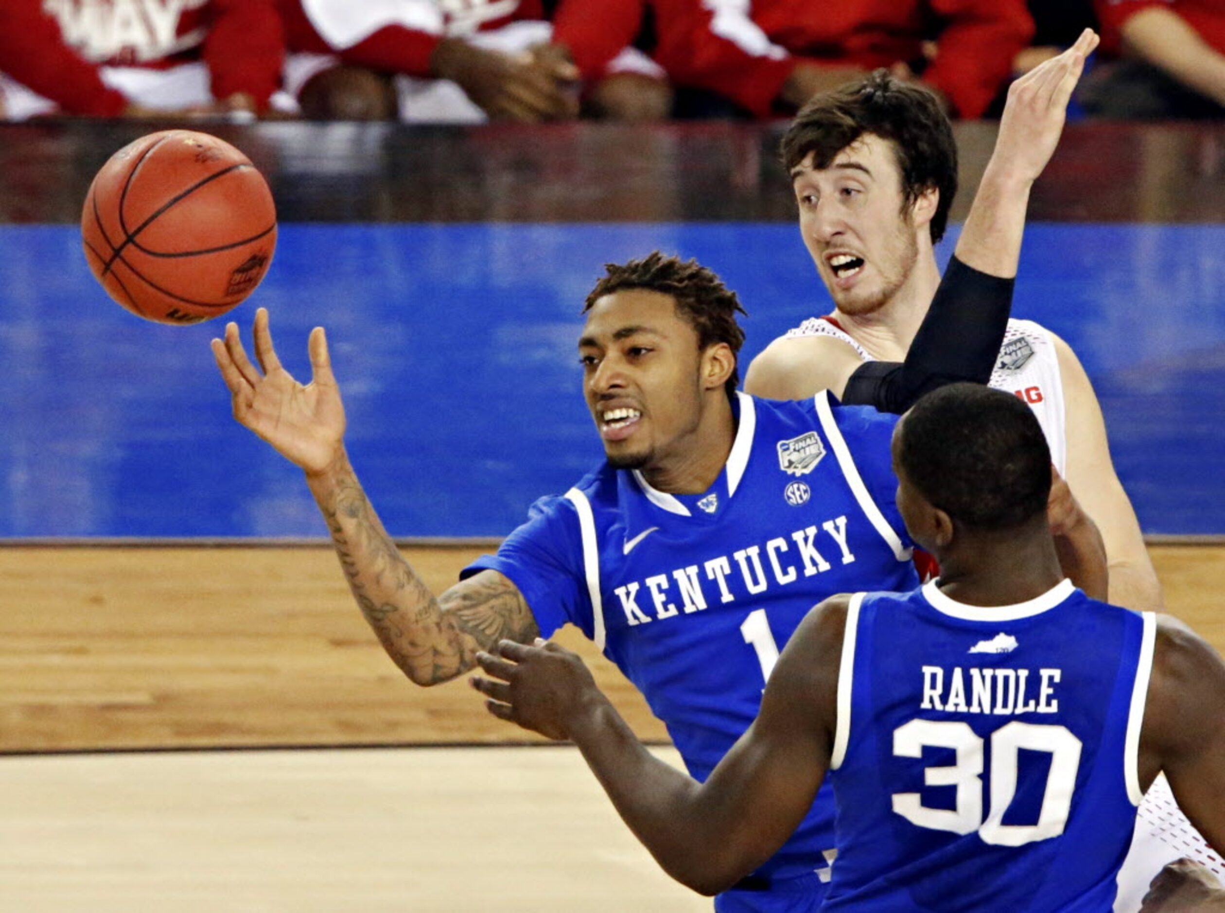 Kentucky Wildcats guard/forward James Young (1) loses control of the ball under pressure...