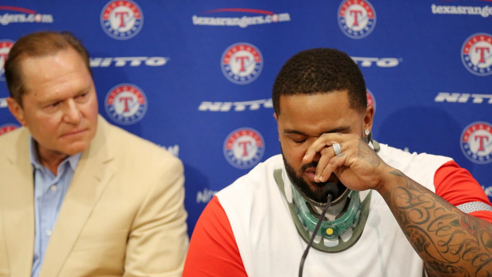 Texas Rangers designated hitter Prince Fielder wipes away a tear while speaking in a press...