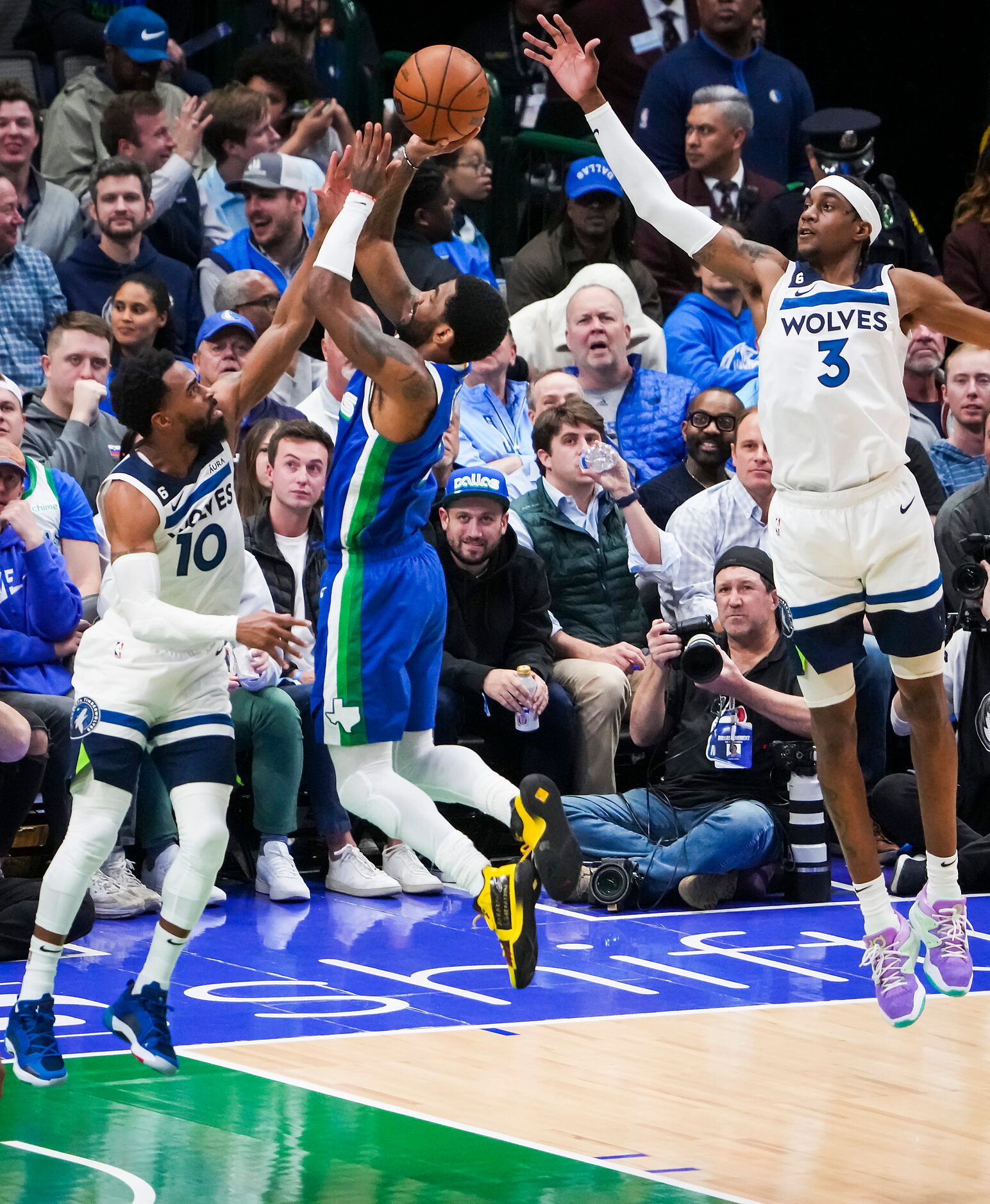 Dallas Mavericks guard Kyrie Irving (2) shoots past Minnesota Timberwolves guard Mike Conley...