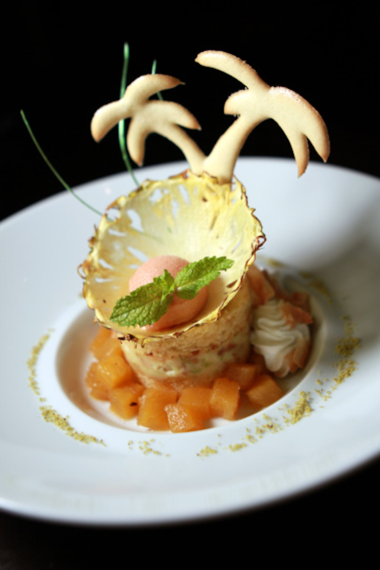 Pineapple upside-down cake with coconut creme patissier and guava sorbet from Cafe on the...