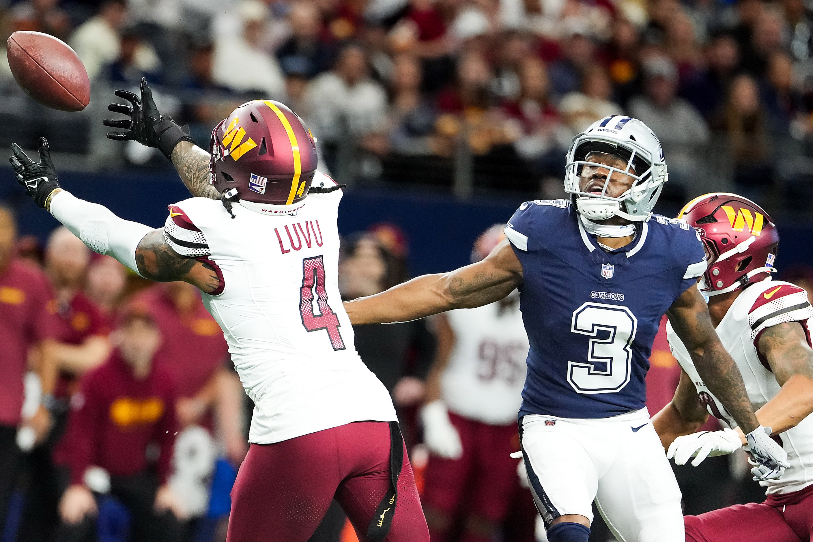 Washington Commanders linebacker Frankie Luvu (4) nearly intercepts a pass intended for...