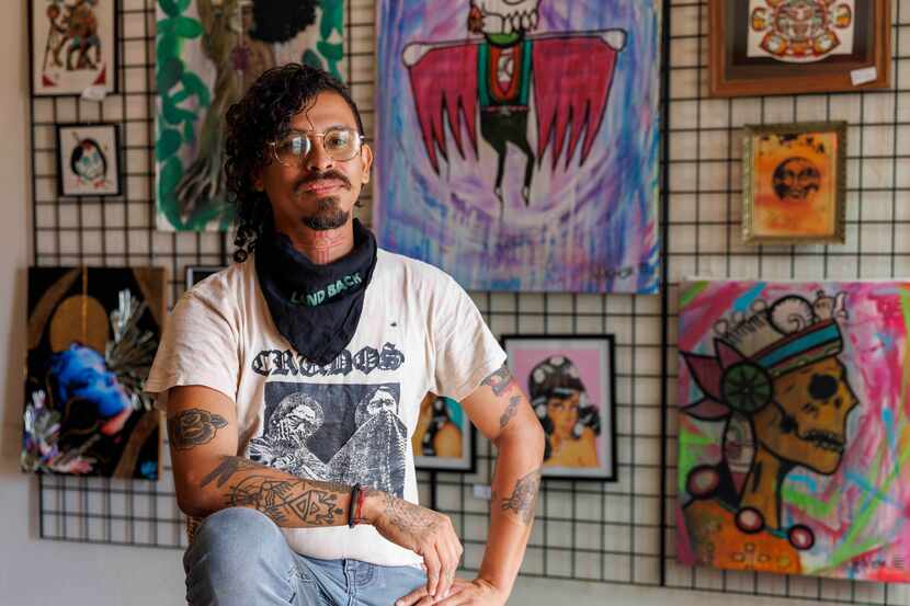 Owner Viktor Ortiz sits in front of artwork at Mi Barrio 214 in Dallas on Nov. 1. Mi Barrio...