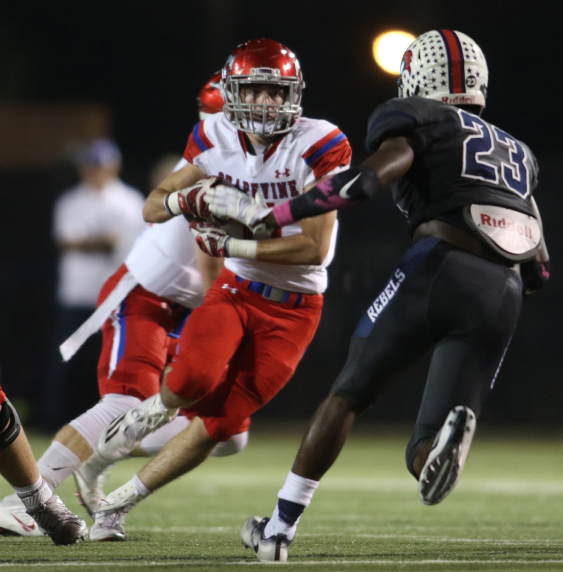 Grapevine running back Zach Wolf (11) eyes Richland defender Dashaun White (23) during a...