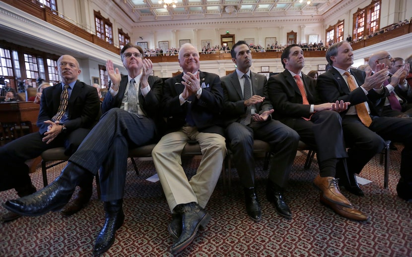 Texas Lt. Gov.-elect Dan Patrick, second from left, Agriculture Commissioner Sid Miller,...