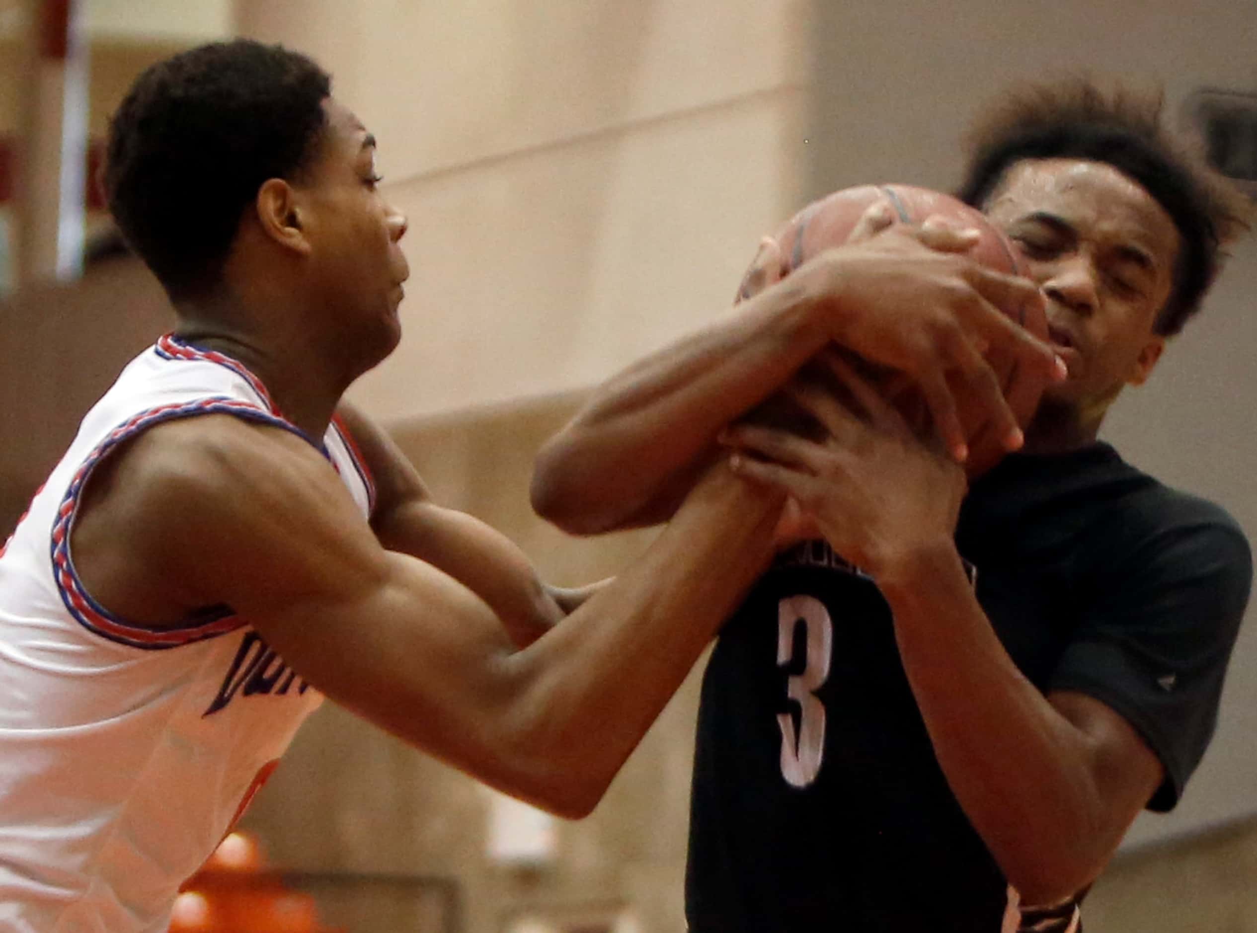 Duncanville guard Zhuric Phelps (0), left, wrestles with Odessa Permian guard Shy Stephens...