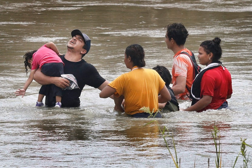 Migrants cross the Rio Grande along the U.S.-Mexico border after being turned away by the...