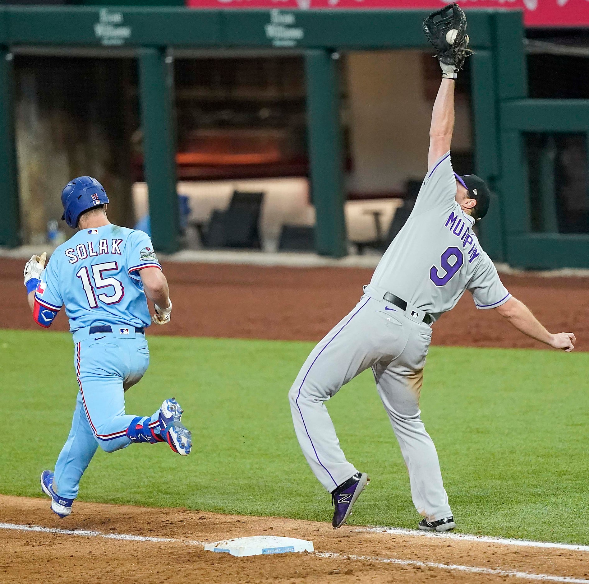 Texas Rangers outfielder Nick Solak is a safe at first base as the throw from Colorado...