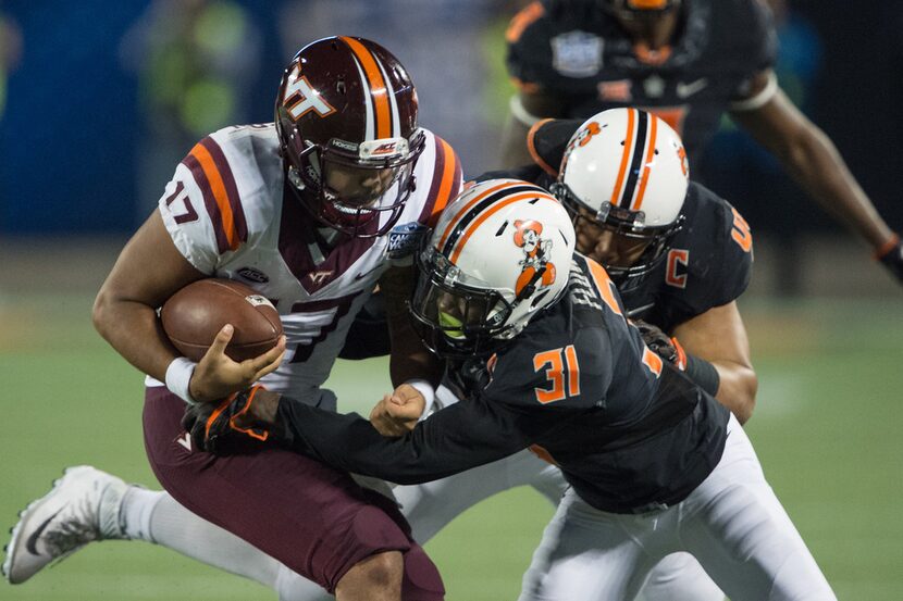 ORLANDO, FL - DECEMBER 28: Safety Tre Flowers #31 of the Oklahoma State Cowboys attempts to...