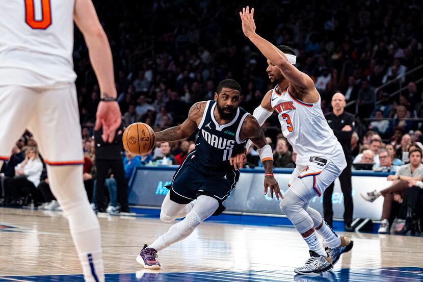 Dallas Mavericks guard Kyrie Irving (11) drives to the basket against New York Knicks guard...