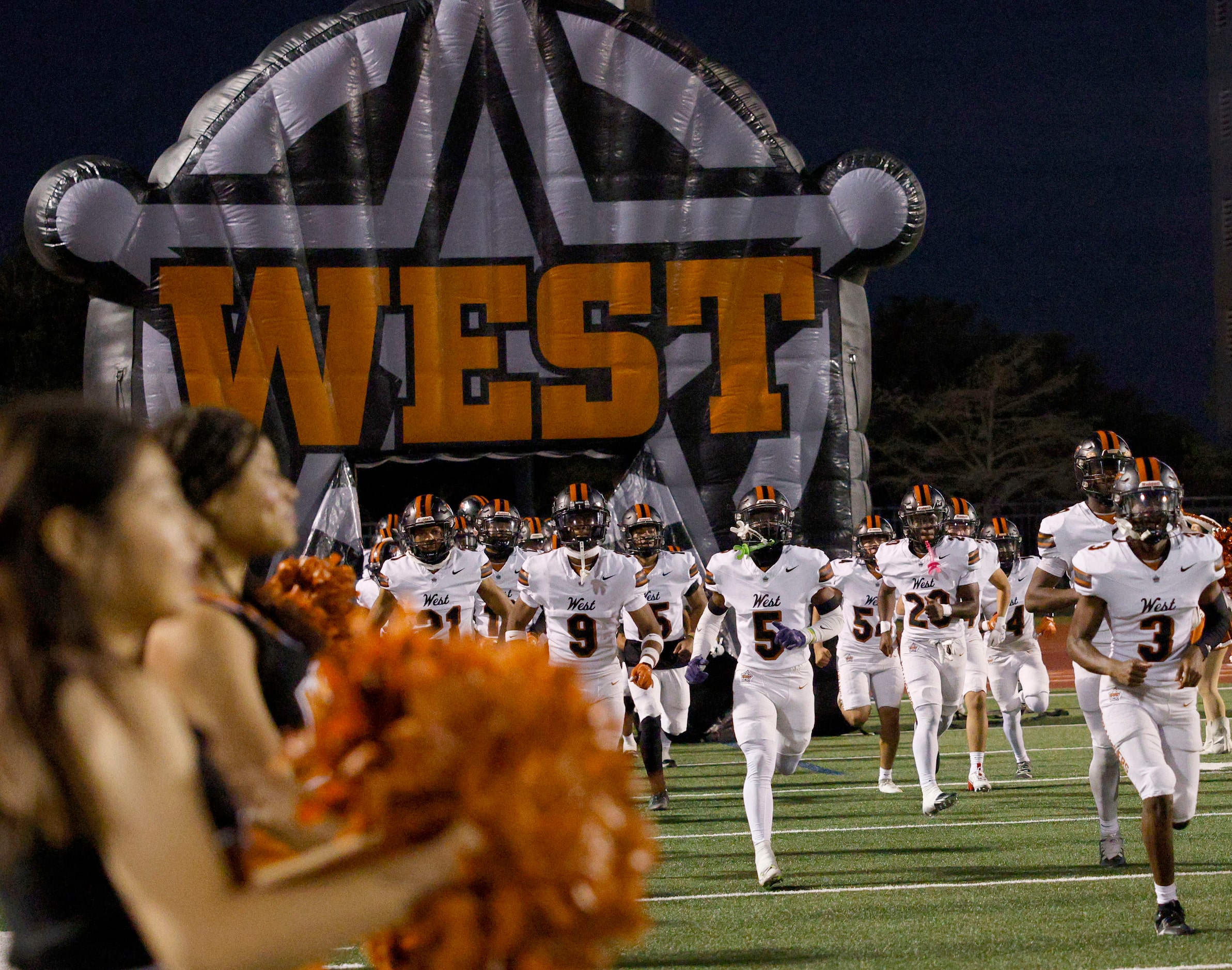 West Mesquite players run onto the field before a high school football game against Newman...