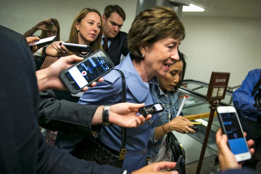 Sen. Susan Collins (R-Maine) talks with reporters as she goes to a weekly Republican policy...