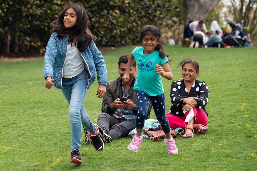 Shriya Achalia, 12, left, races with her sister Navya Achalia, 7, both of Austin, during a...