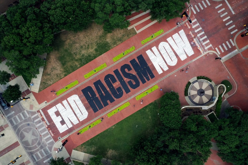 An aerial view from a drone as residents view the "End Racism Now" mural painted on Main...