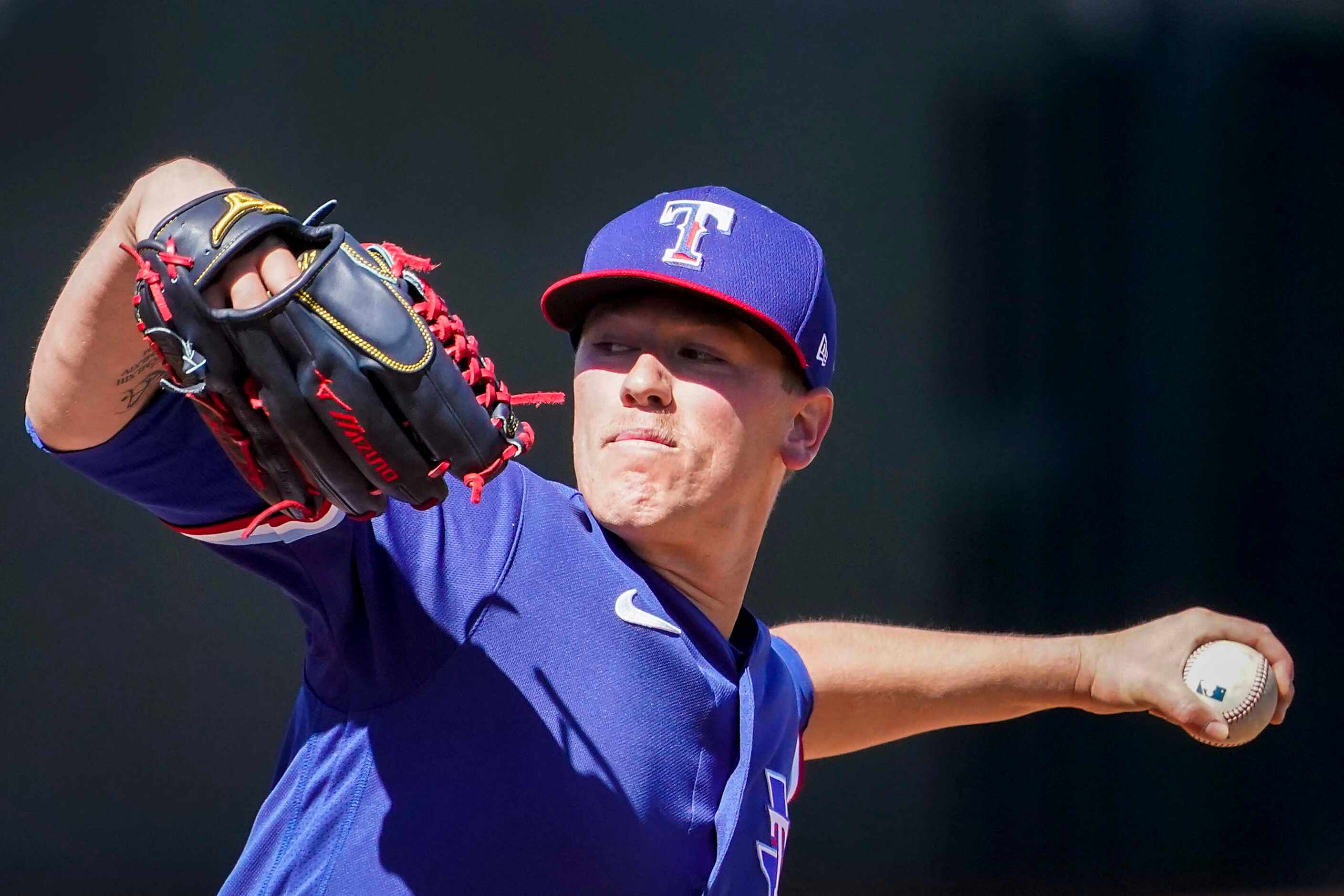 Texas Rangers pitcher Kolby Allard delivers during the second inning of a spring training...