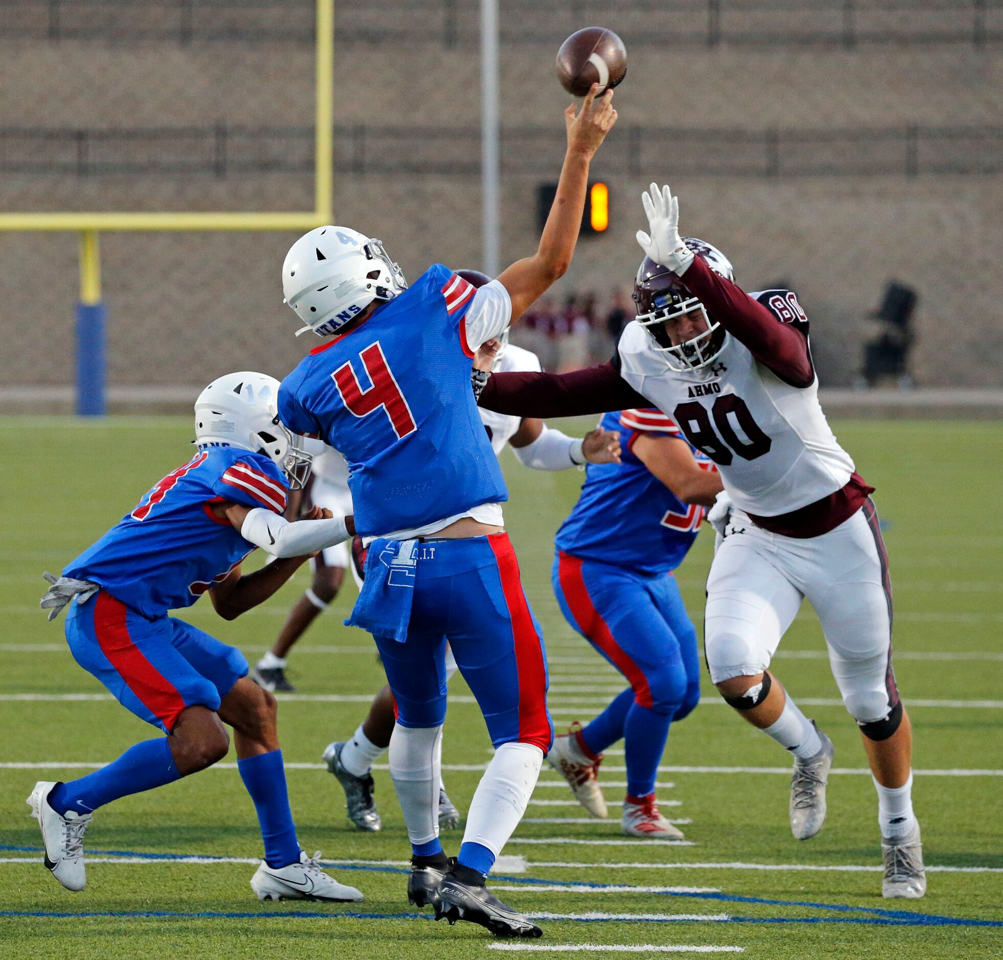 South Garland High QB Mirko Martos (4) throws under pressure from Wylie High defender Dane...