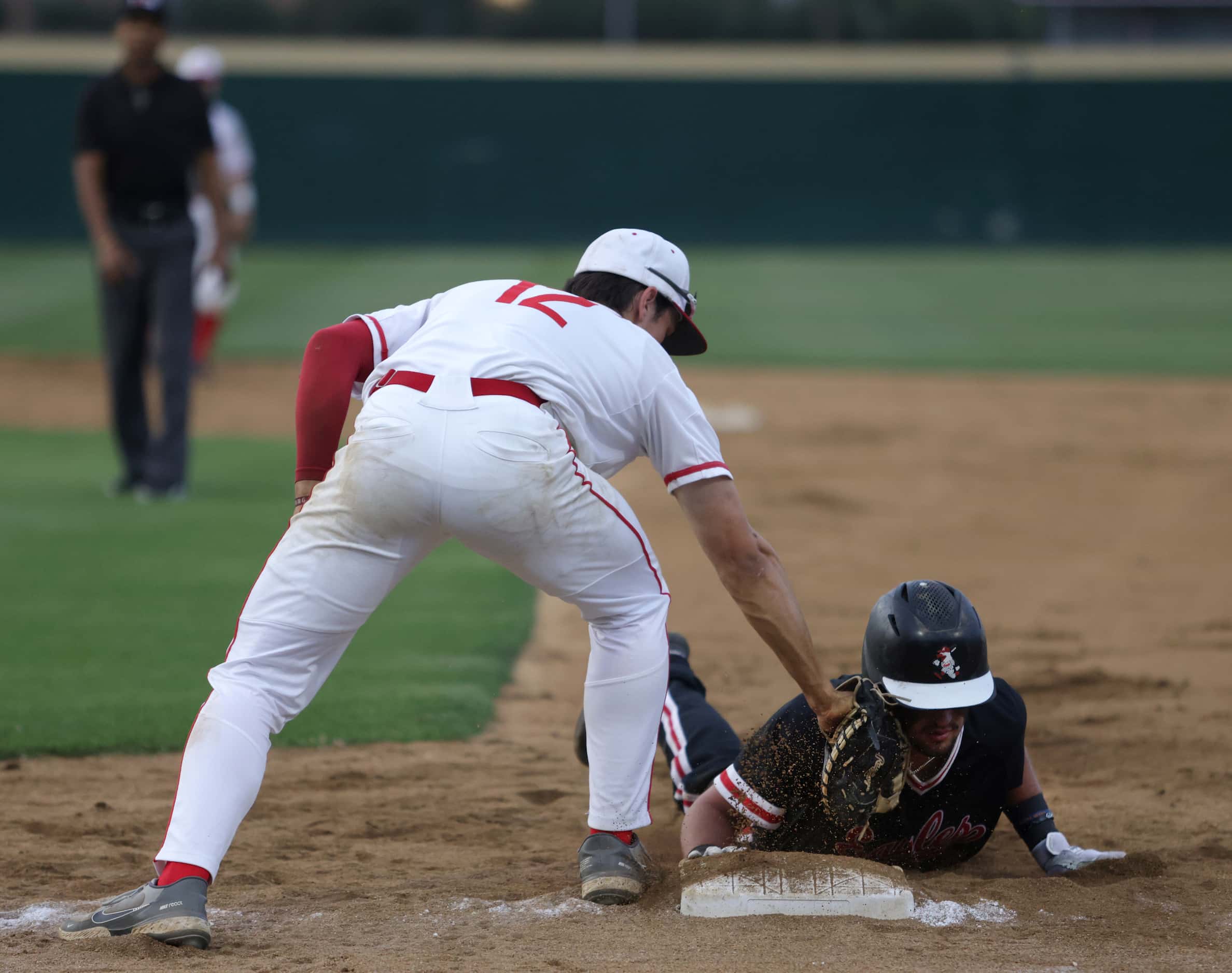Argyle High School player Colton Roquemore slides back into first base as Grapevine High...