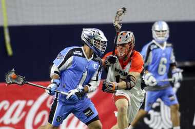 Ohio Machine attacker Marcus Holman (1) surveys the defense as Denver Outlaws midfielder...