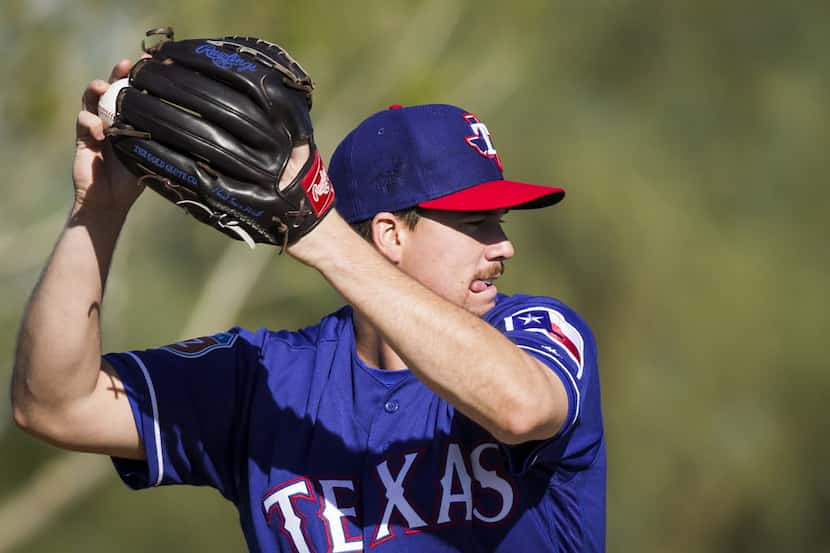 Texas Rangers pitcher Chi Chi Gonzalez participates in a fielding drill during a spring...