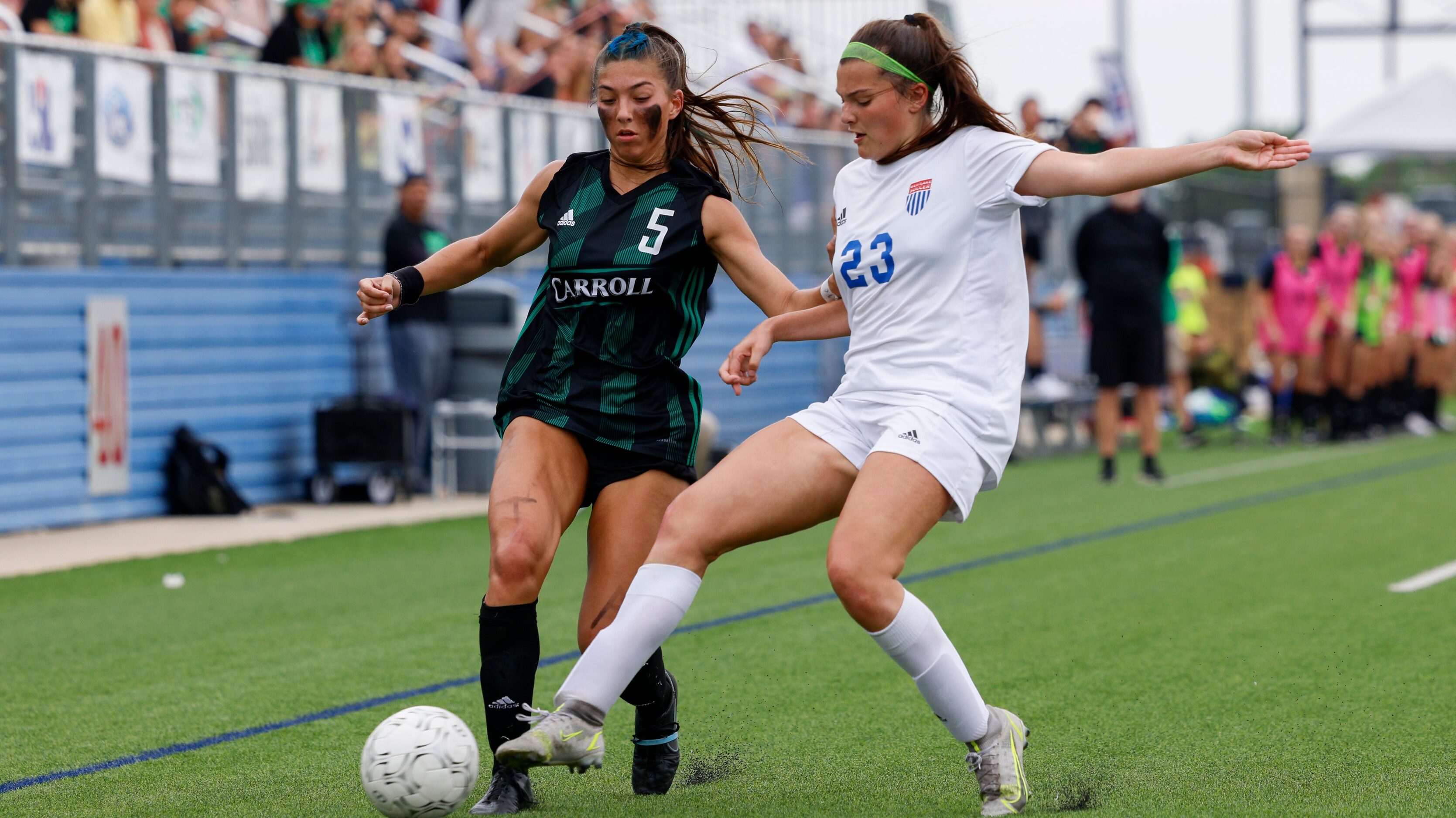 Austin Westlake defender Alex Biles (23) tackles the ball away from Southlake Carroll...