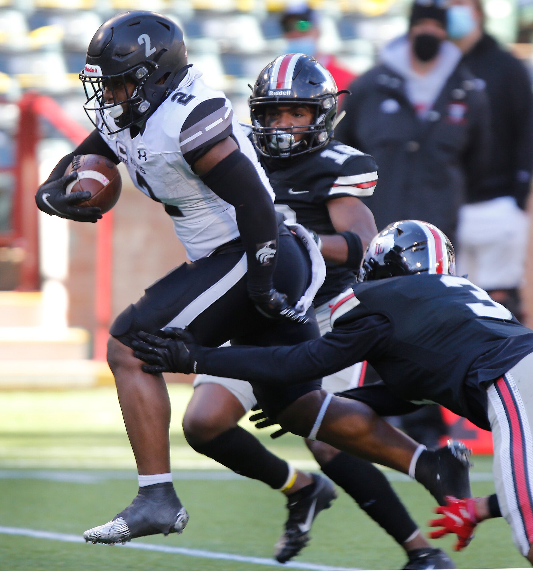 Mansfield Timberview High School running back Deuce Jones (2) breaks through a tackle...