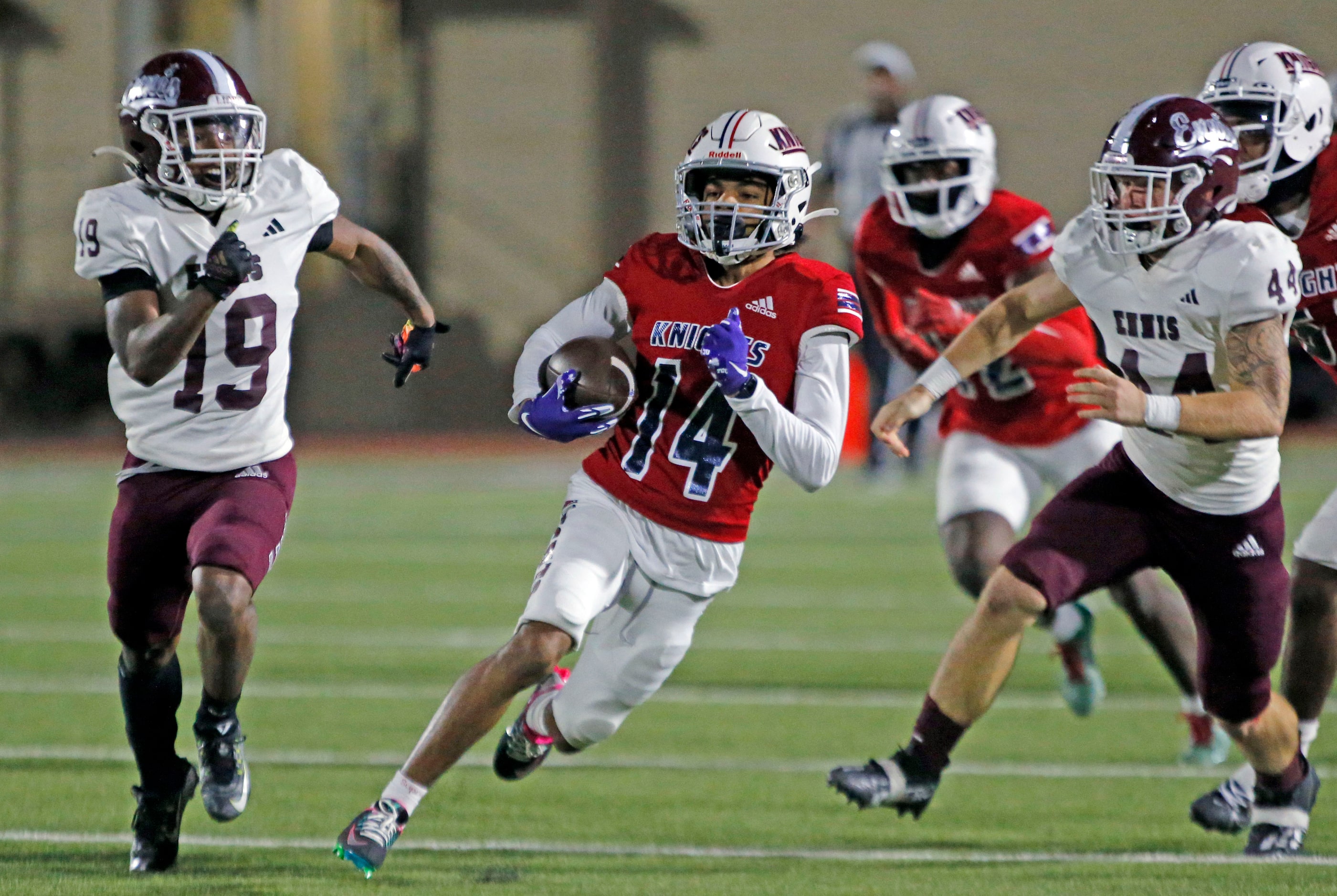 Kimball high’s Syn’kiun Washington (14) grinds out yardage during the first half of a high...