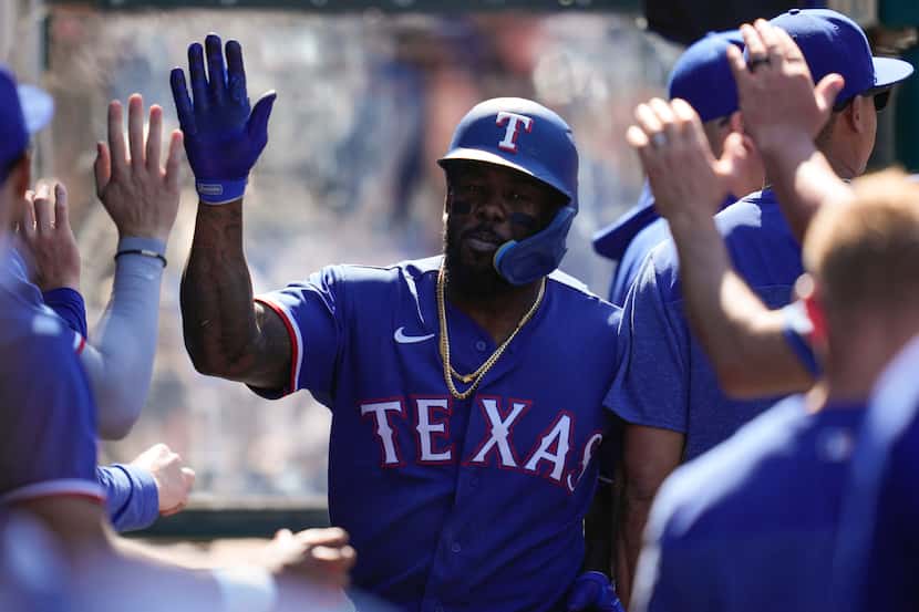 Texas Rangers designated hitter Adolis Garcia (53) celebrates in the dugout after hitting a...