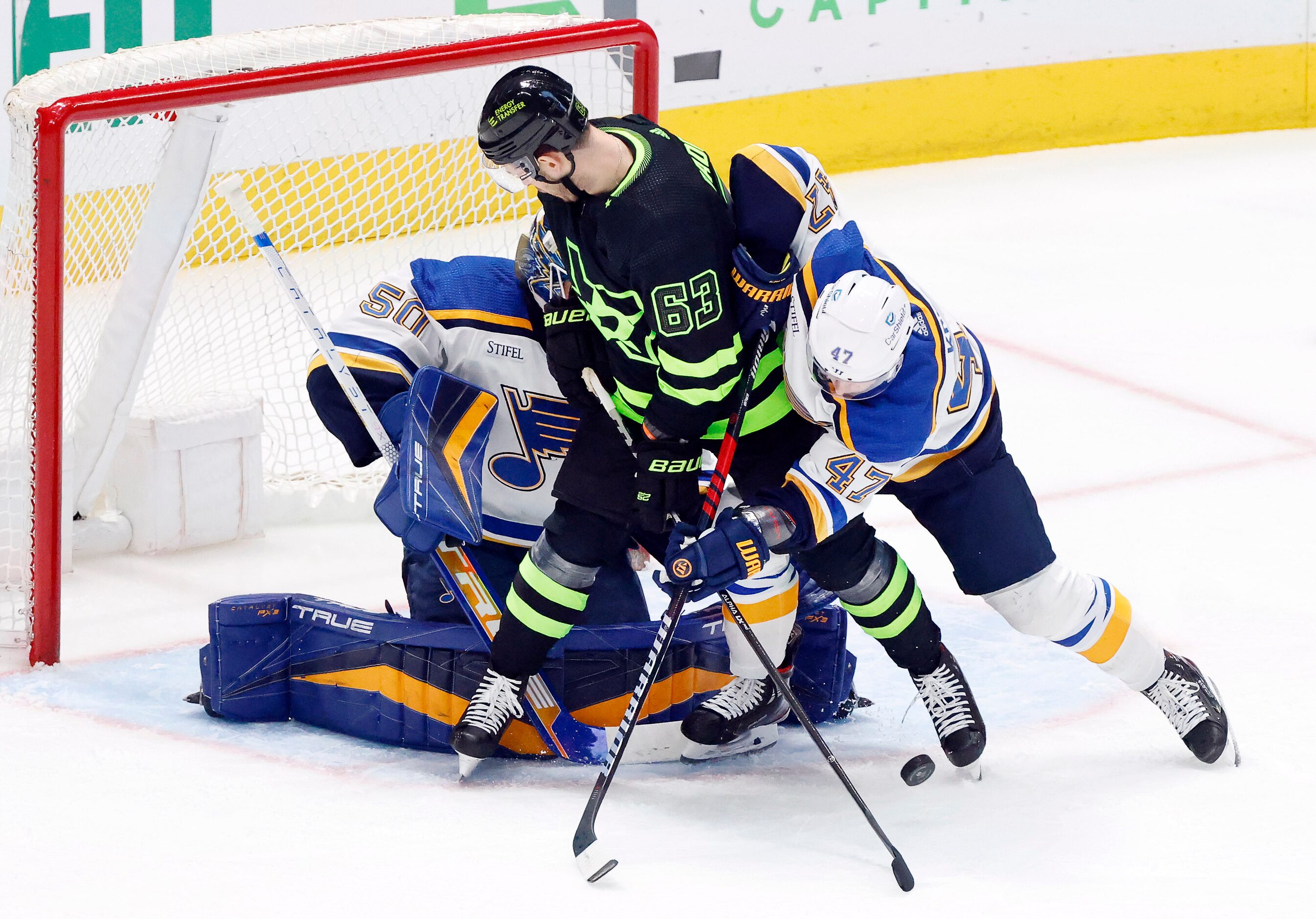 St. Louis Blues defenseman Torey Krug (47) pushes Dallas Stars right wing Evgenii Dadonov...