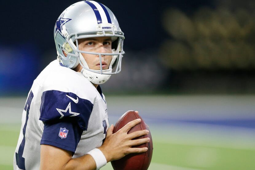 Dallas Cowboys quarterback Kellen Moore (17) drops back to pass in a drill at practice...