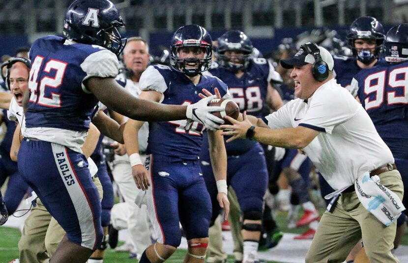 Allen defensive lineman Jayden Jernigan (42) hands the ball to Eagles' defensive coordinator...