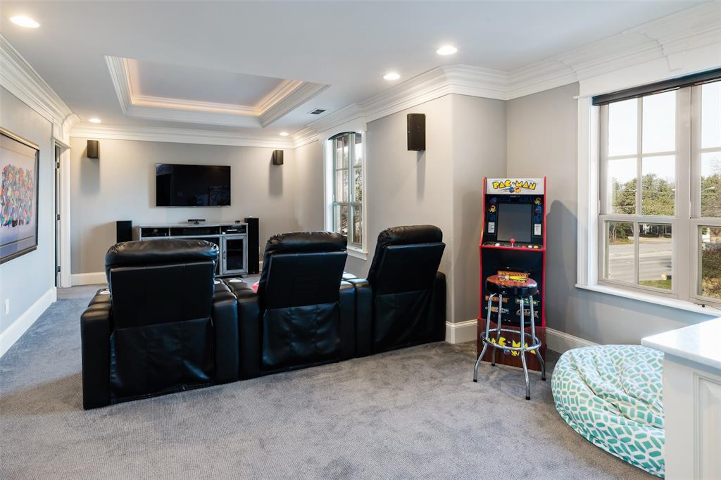 Gray media room with three recliners.