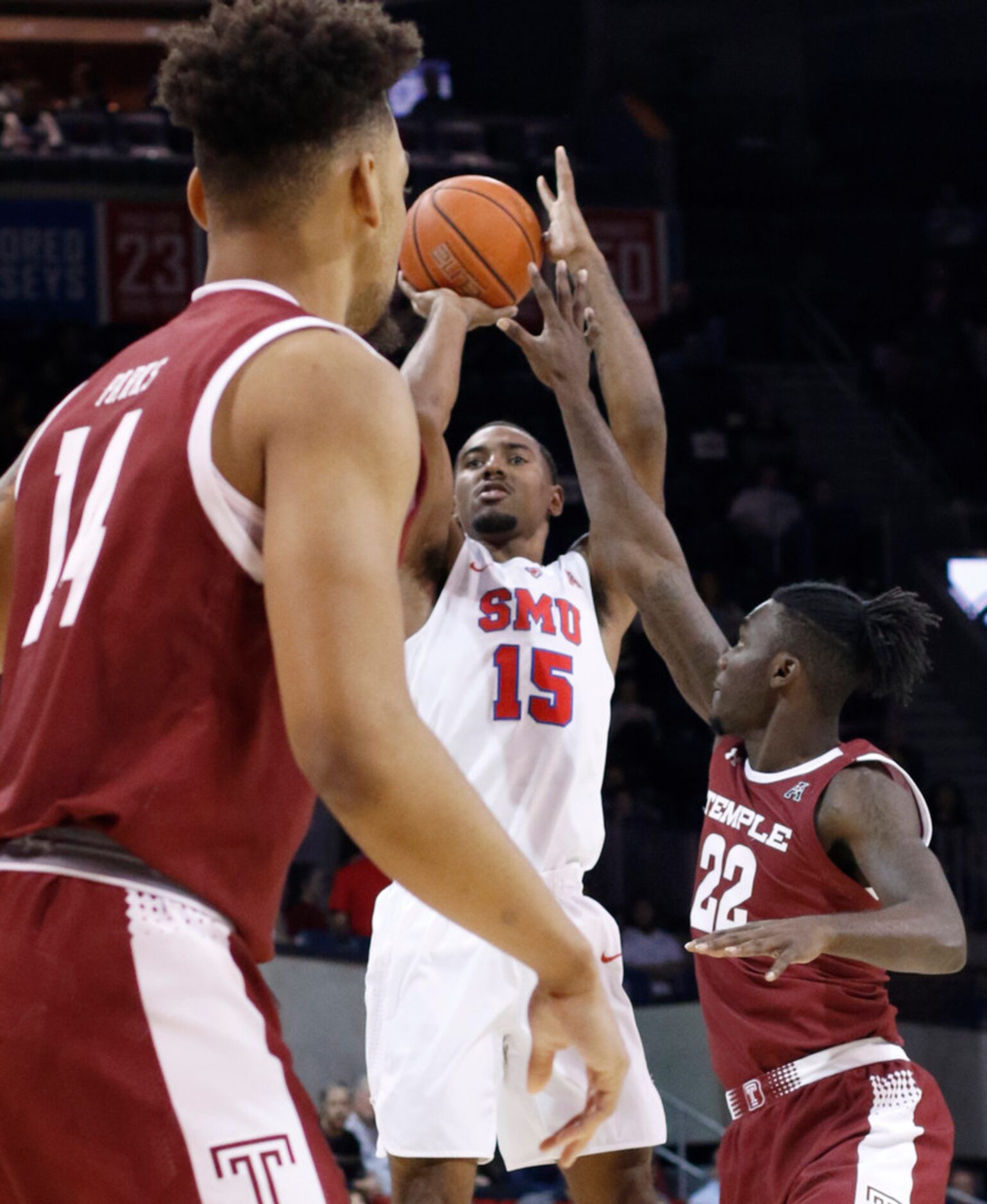 SMU forward Isiaha Mike (15) gets off a jumper between Temple defenders De'Vondre Perry (22)...