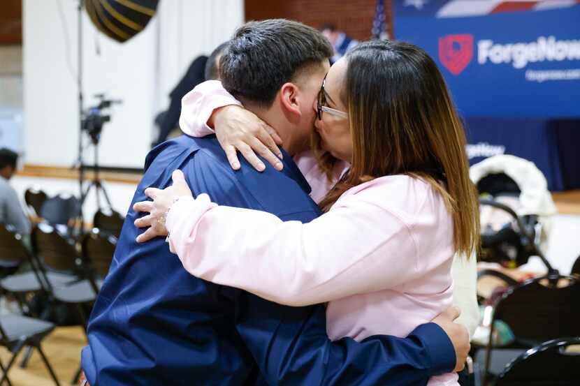 Electrical Wiring program candidate Norberto Del Fierro Jr., (left) embraces his mother Mary...