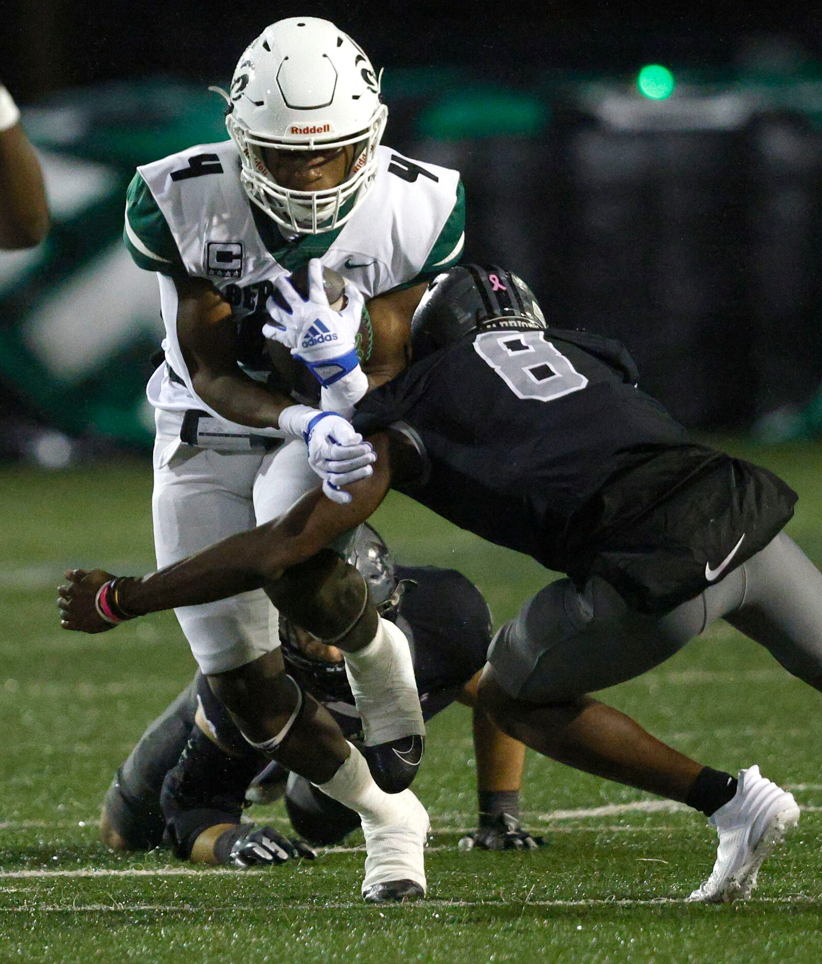 Berkner's Jamary Williams (4) is tackled by Martin's Jordan Talley (8) during the first half...