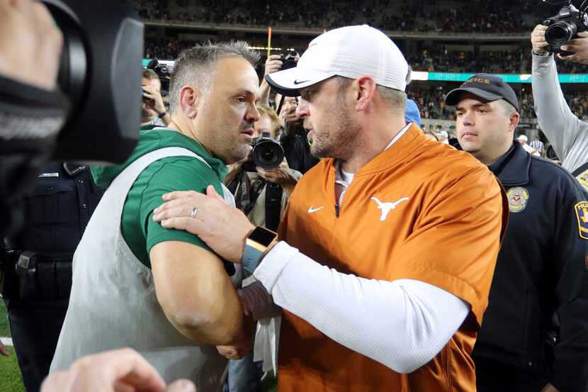 Baylor head coach Matt Rhule, left, and Texas head coach Tom Herman shake hands after an...