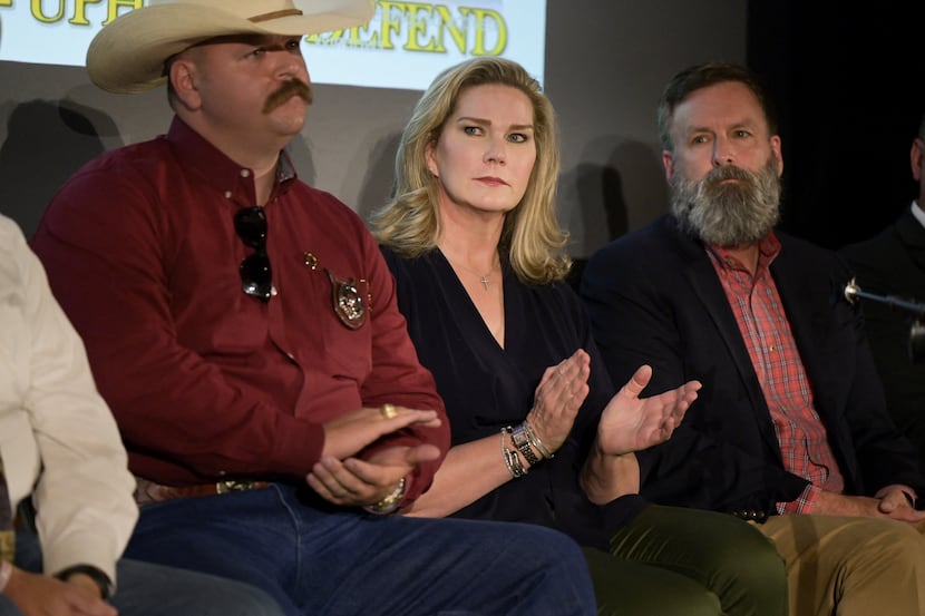 Catherine Engelbrecht, founder of True the Vote, applauds during a news conference in Las...