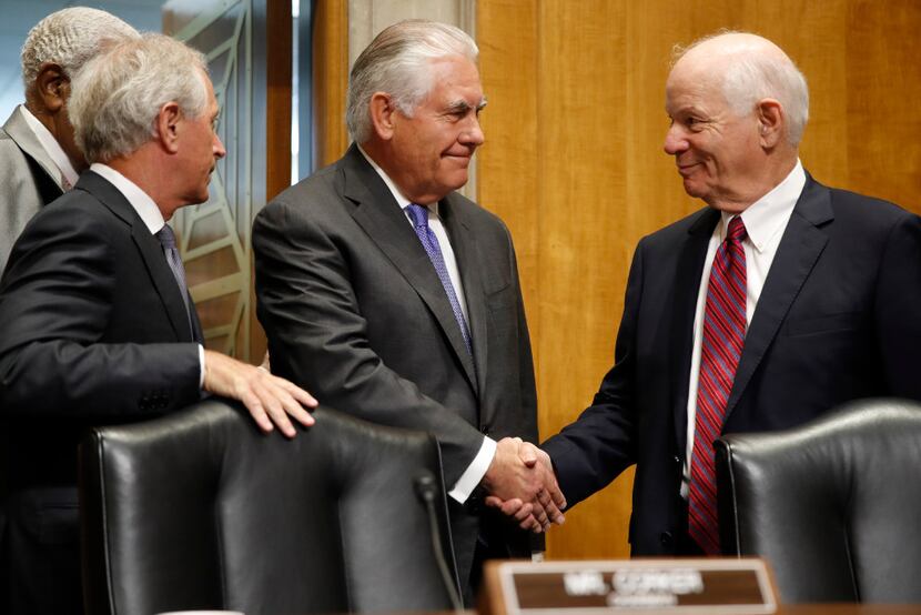 Secretary of State Rex Tillerson (center) is greeted on Capitol Hill in Washington on...