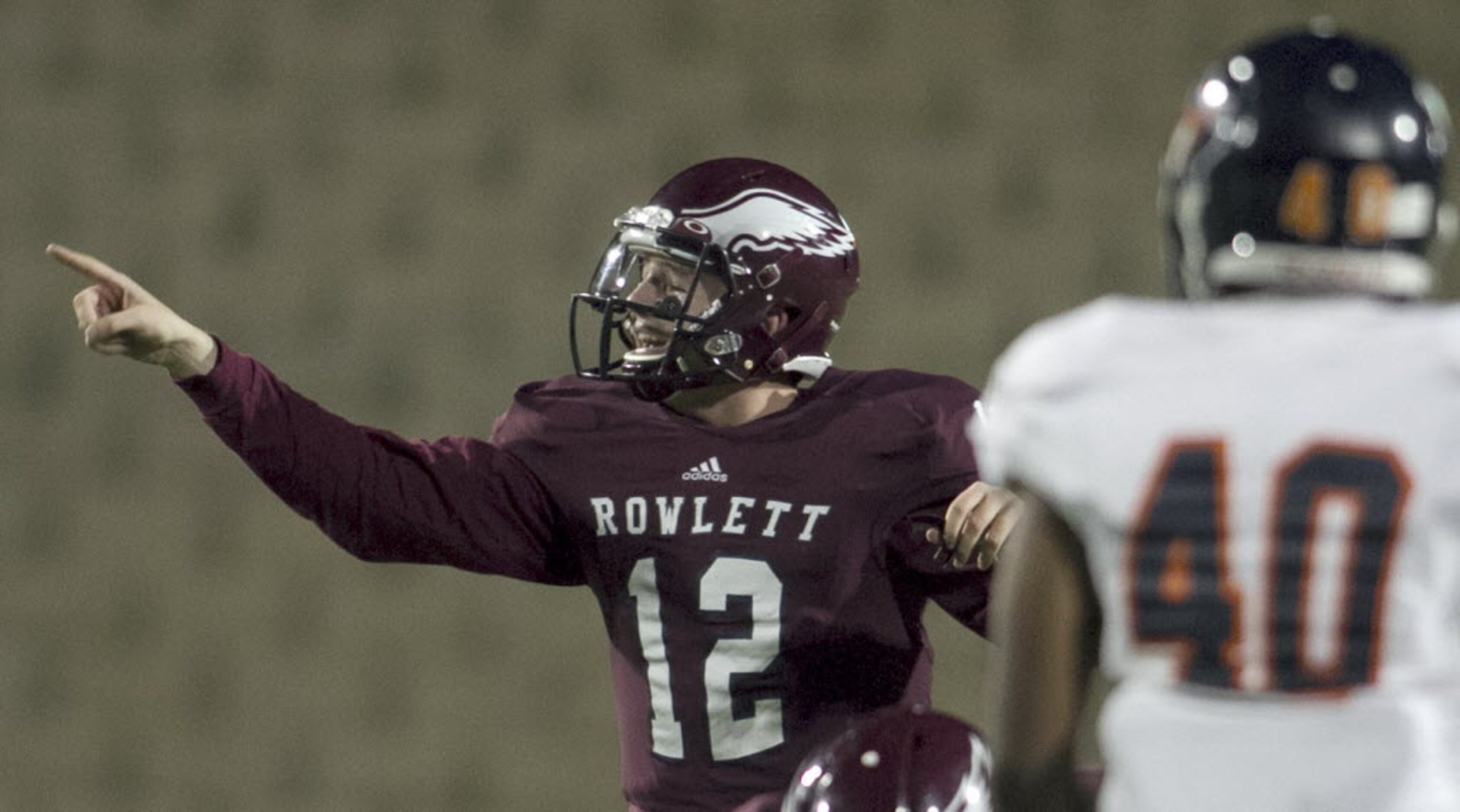 Rowlett quarterback Logan Bonner (12) directs one of his receivers during first quarter...