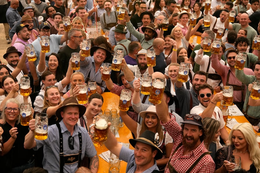 Festival enjoy the first glasses of beer on day one of the 189th 'Oktoberfest' beer festival...