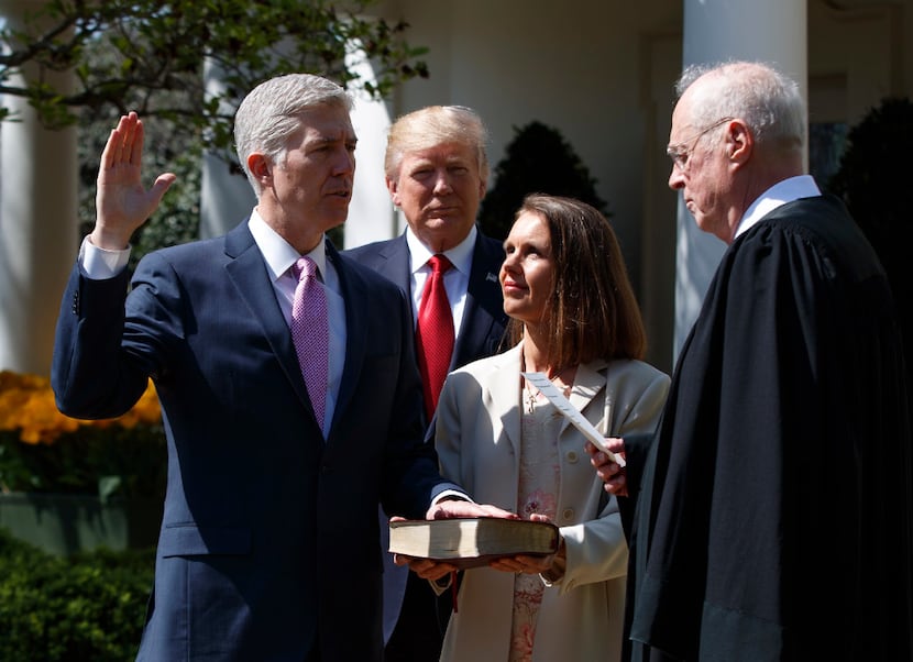 Supreme Court Justice Anthony Kennedy administers the judicial oath to his newest colleague,...