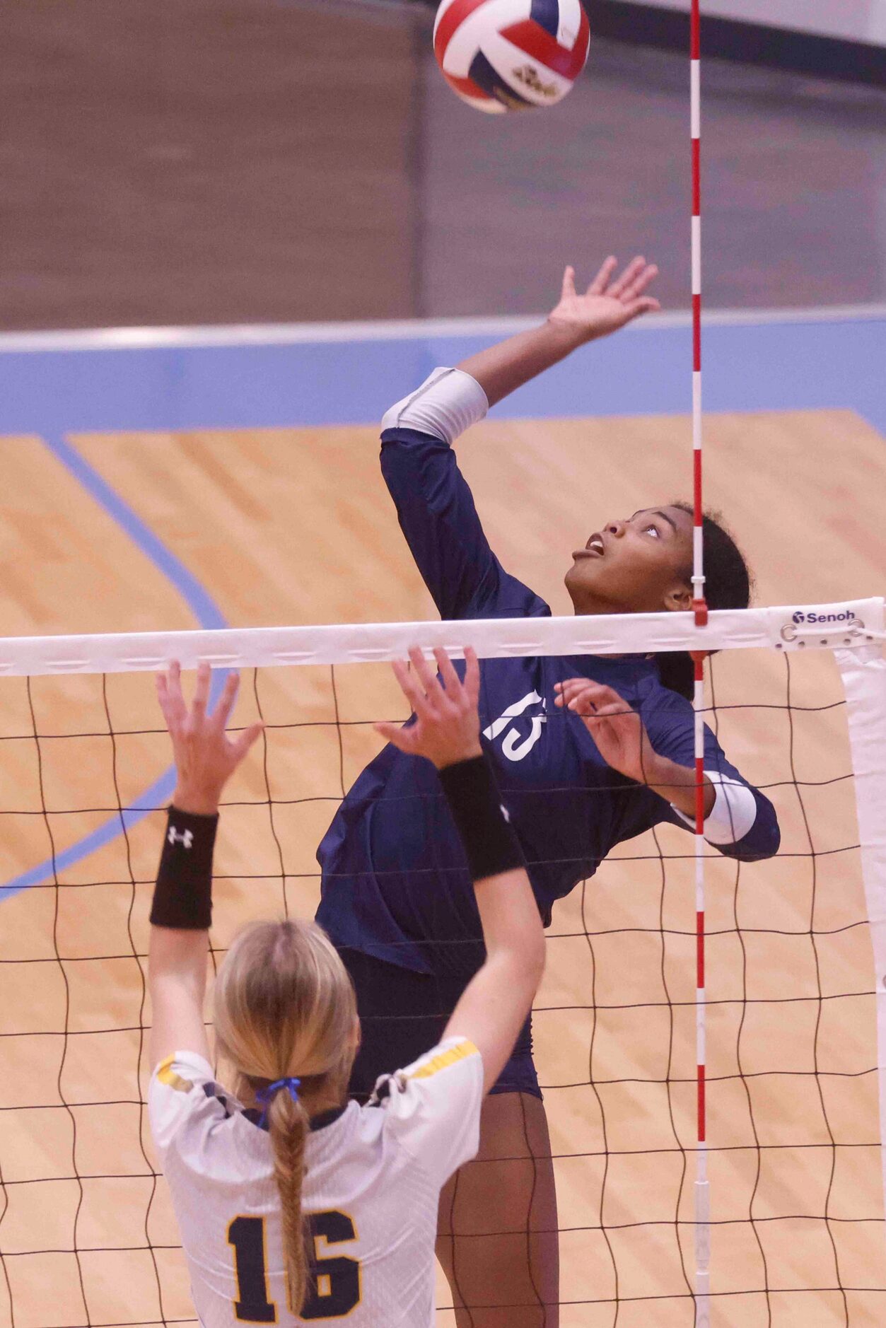 Flower Mound’s Brianna Watson (13) spikes against Highland Park High’s Nicole Mauser (16)...