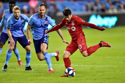 Toronto FC's Alejandro Pozuelo, right, kicks toward the goal against New York City FC during...