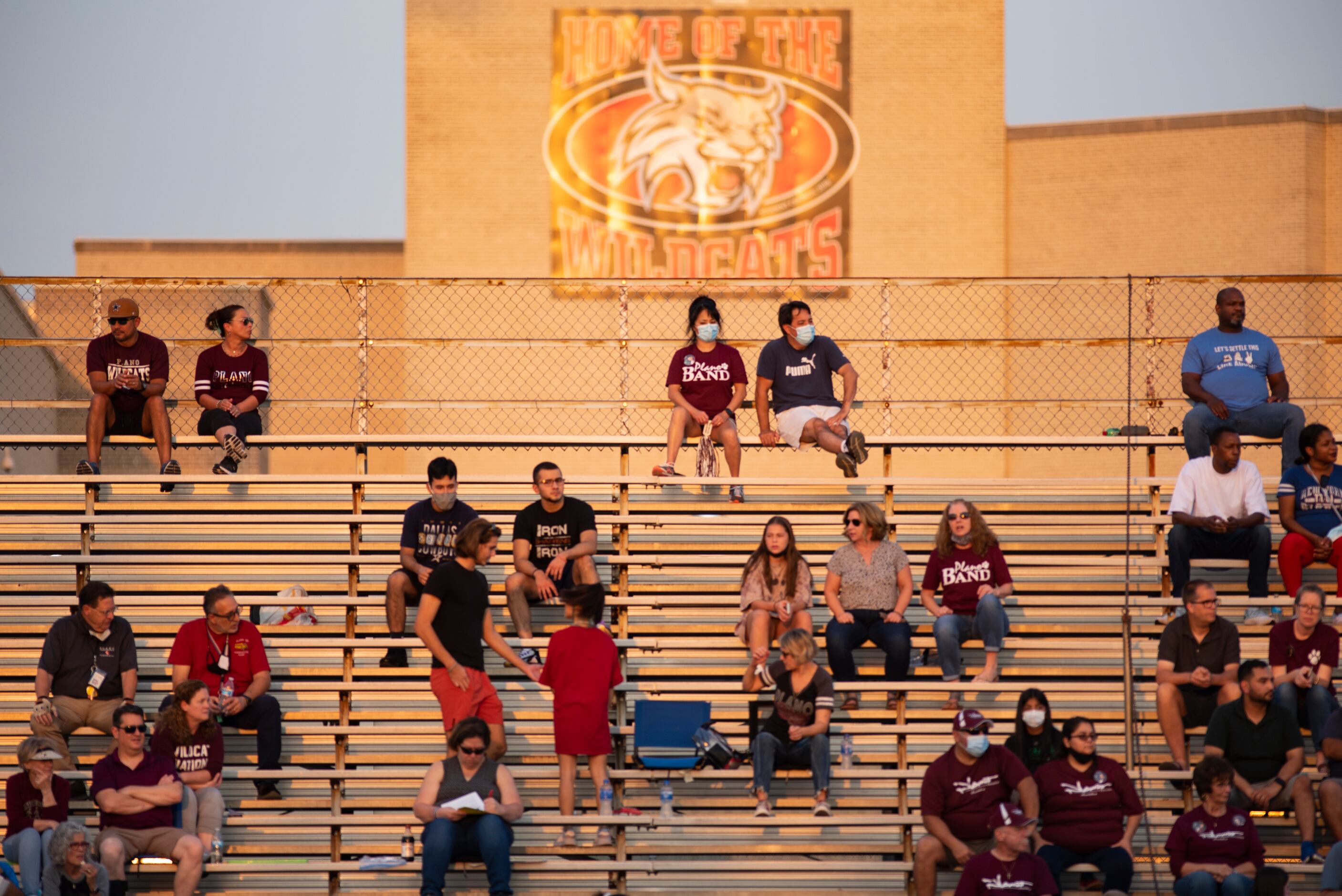 Fans sit at a distance during Lake HighlandÕs home game against Plano Senior High School at...