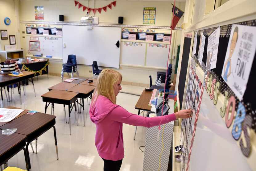 Katherine Alford organizes a education bulletin board as she prepares her fourth-grade math...