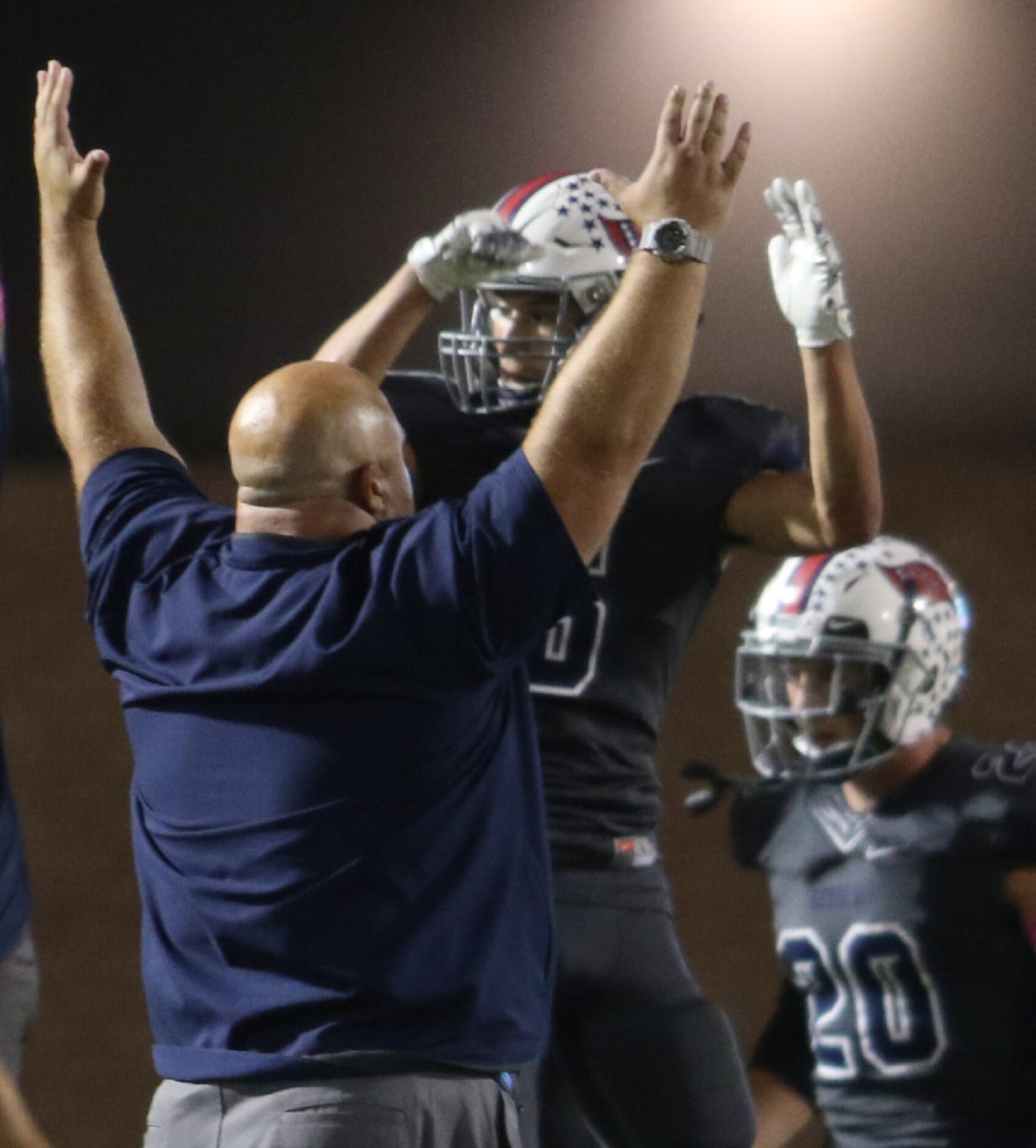 Richland strength and conditioning coach Monte Sparkman lifts his hands as he celebrates...