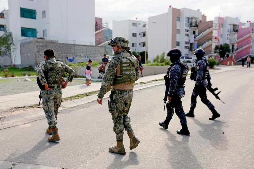 The Mexican Federal Police, Mexican Army and local municipal police respond to a shooting at...