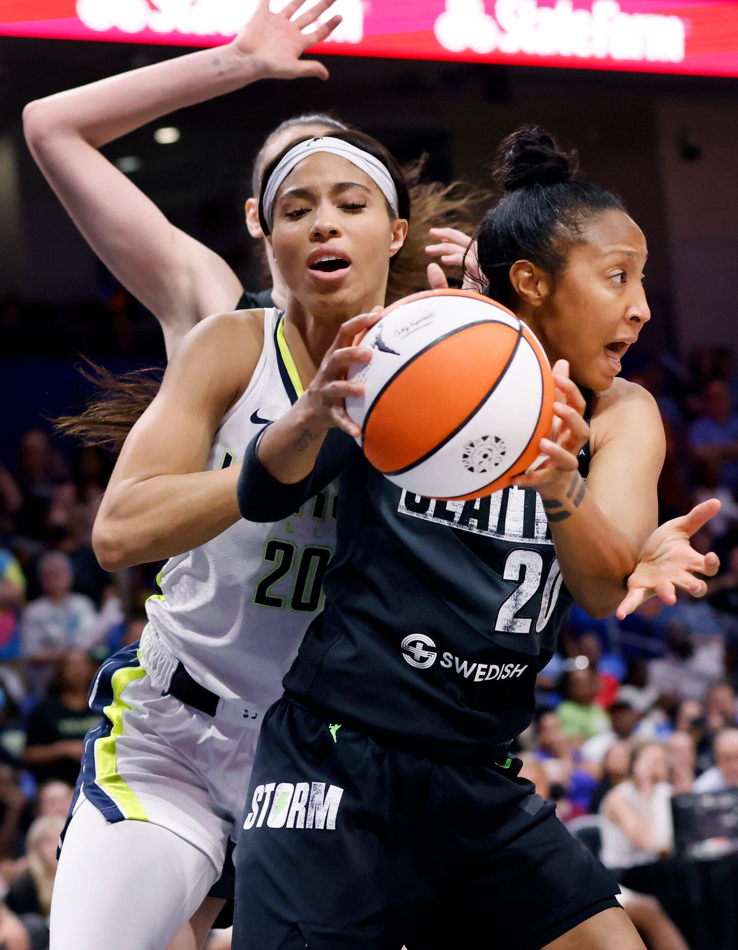 Dallas Wings forward Isabelle Harrison (20) fouls Seattle Storm guard Briann January (20)...