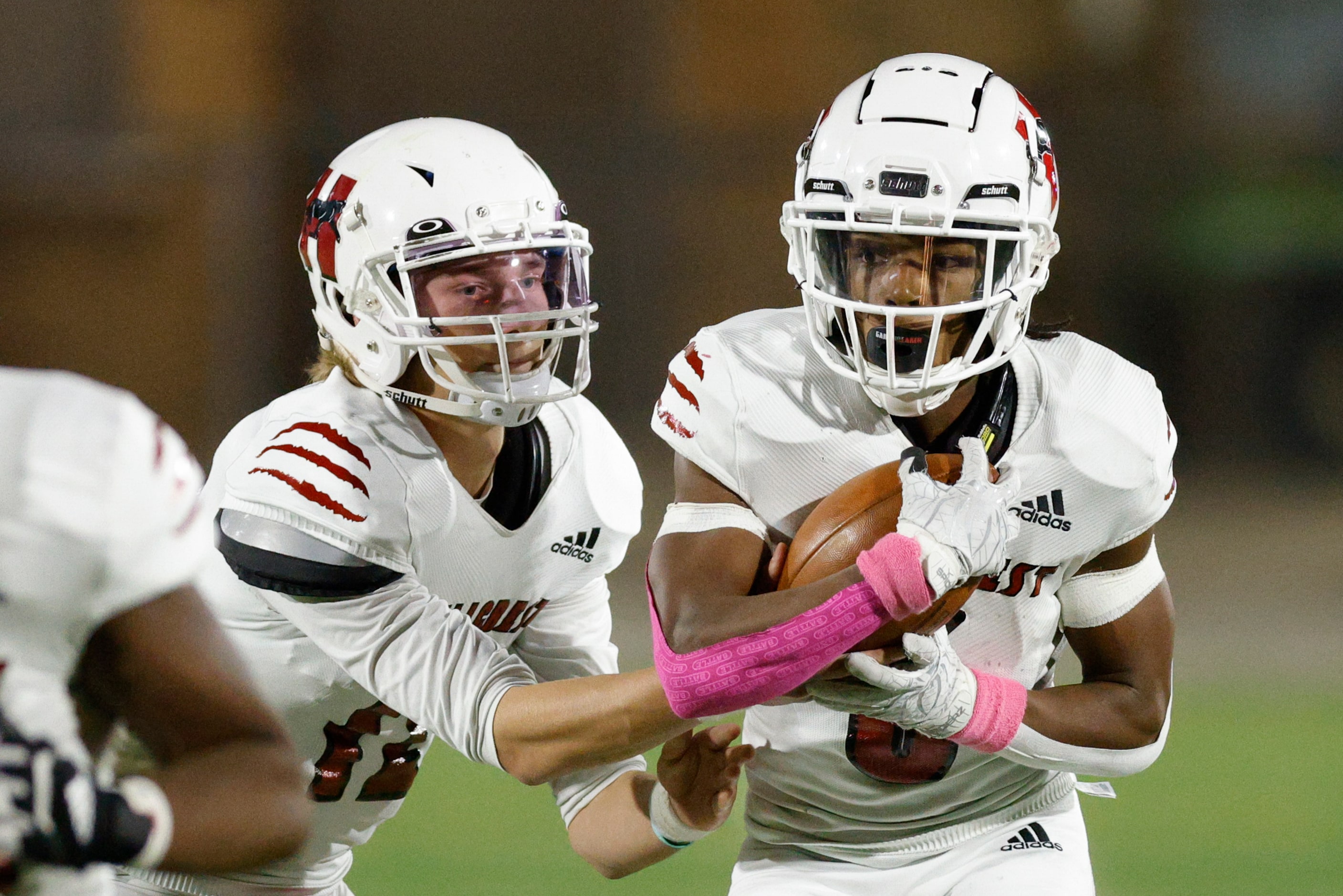 Hillcrest quarterback Luke Monter (12) hands the ball to  wide receiver Jaden Hodge (6)...