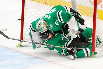 Dallas Stars defenseman Miro Heiskanen (4) slides into goaltender Scott Wedgewood (41)...